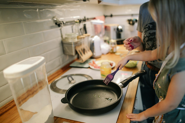 Mother and daughter cooking in kitchen with professionally cleaned tile backsplash