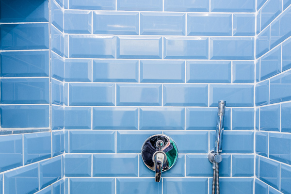 Bathroom tiled shower with shiny clean tiles and grout